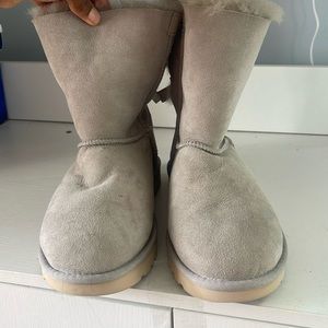 Grey UGG boot with bow detailing in back
